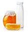 Sweet honey in glass jars with honeycombs and bottle of milk iso