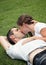 Sweet image of young couple kissing on the grass