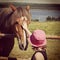 Sweet instagram of young girl petting horse