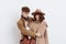 a sweet, joyful, pleasant stylish couple stands on a white background in autumn coats and gently hug each other, a woman