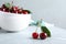 Sweet juicy cherries with leaves on marble table, closeup