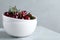 Sweet juicy cherries with leaves on marble table, closeup