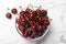 Sweet juicy cherries on white marble table