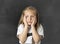 Sweet junior schoolgirl crying sad in children education stress and bullying victim