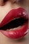 Sweet kiss. Close-up of woman\'s lips with fashion red make-up. Beautiful female mouth, full lips with perfect makeup