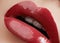 Sweet kiss. Close-up of woman\'s lips with fashion red make-up. Beautiful female mouth, full lips with perfect makeup