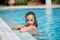 Sweet lady in the pool looking at the camera