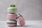 Sweet lavander, mint and pistachio macaroons on light background