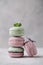 Sweet lavander, mint and pistachio macaroons on light background