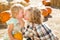 Sweet Little Boy Kisses His Baby Sister in a Rustic Ranch Setting at the Pumpkin Patch