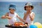 Sweet little children, twin boys, celebrating their sixth birthday on the beach