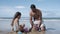 Sweet little girl and her dad building sand castle