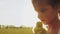 Sweet little girl holds fluffy yellow duckling in hands