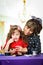 Sweet little girl making crafts with her mother