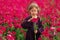 Sweet little girl in a meadow with wild spring flowers