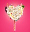 Sweet Lolipop in Heart form of whipped cream with sweets, jellies, heart front view. Crazy freakshake food trend. Front