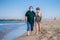 Sweet loving mature couple in face mask during covid19 - senior retired husband and wife on their 70s enjoying beach walk relaxed