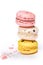 Sweet macaroons macarons stack  on white background. French cookies with vanilla, lemon and strawberry