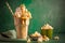 Sweet Milkshake with caramel syrup, cream liqueur, caramel popcorn on green background. Summer healthy dessert concept with copy