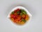 Sweet mixed color jelly candy in a white bowl against white background