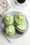 Sweet muffins with pistachio icing. Sweet dessert on kitchen table