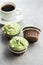 Sweet muffins with pistachio icing. Sweet dessert on kitchen table