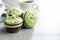 Sweet muffins with pistachio icing. Sweet dessert on kitchen table