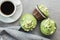 Sweet muffins with pistachio icing. Sweet dessert on kitchen table