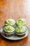 Sweet muffins with pistachio icing. Sweet dessert on wooden table