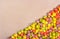 Sweet multicolored popcorn on paper background. Fruit caramel popcorn.