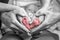 sweet newborn family forming Baby feet heart baby& x27;s feet in mom and dad parent hands selective color
