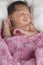 sweet newborn girl wrapped in a pink blanket