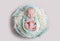 Sweet newborn wrapped in a nappy sleeping on a round rug