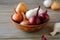 Sweet onions and dried husk in a bowl on wooden boards