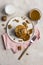 Sweet pancakes with boiled condensed milk and walnuts on plate with fork and knife, milk in glass and caramel in jar near, at
