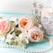 Sweet pastel roses, jasmine flowers and candle