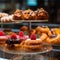 Sweet pastries with berries. Showcase in a candy store. Glass stand with cake eclairs and tartlets.