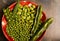 Sweet peas and broad bean on gingham plate