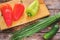 Sweet pepper on a cutting Board, onion, cucumber on a wooden background