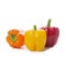 Sweet peppers, yellow, red and orange paprika on white background