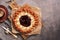 Sweet pie with cottage cheese with strawberry jam, a cup of hot coffee, rustic dark background. Top view, flat lay, copy space