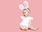 Sweet pink cute baby in costume easter bunny