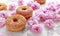 Sweet pink fresh Donut decorated with japanese Flowering Cherry Tree flower