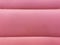 Sweet pink leather sofa seating surface skin wall background.