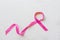 Sweet pink ribbon shape on gray background for Breast Cancer Awareness symbol to promote in october month campaign. Flat lay with