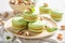 Sweet pistachio macaroons on table with flowers