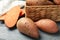 Sweet potato in basket on wooden table