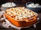 Sweet potato casserole topped with marshmallows in baking dish on a table. Festive winter dish served for Thanksgiving Day family