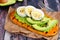 Sweet potato toast with avocado, eggs and chia seeds, table scene