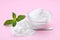 Sweet powdered fructose and mint leaves on pink background